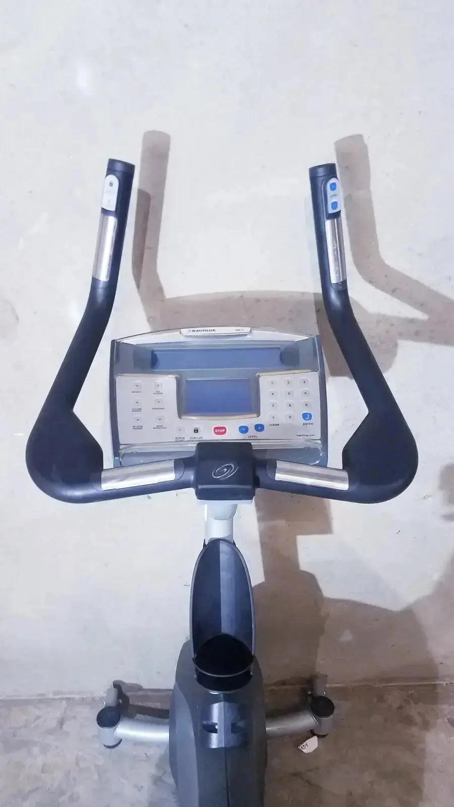 Black and silver schwinn blue indoor cycling bike with digital display panel from Nautilus Commercial Series