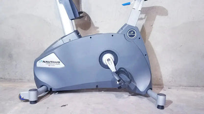 Gray nautilus commercial series schwinn blue indoor cycling bike with sleek design and black pedal accents