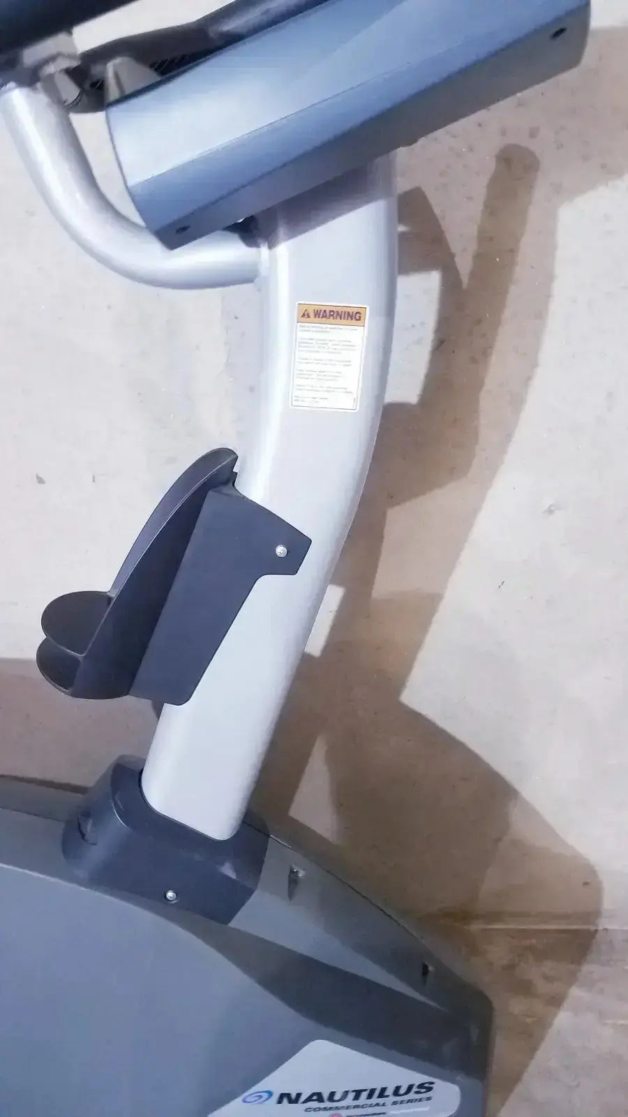 Gray and black nautilus exercise bike with sleek modern design in schwinn blue indoor cycling bike series