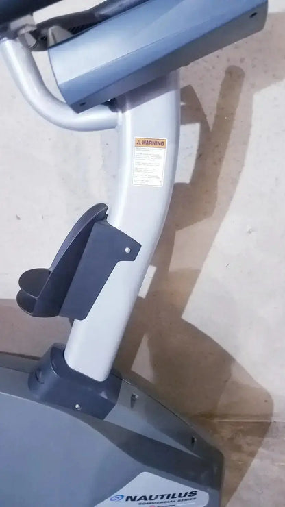 Gray and black nautilus exercise bike with sleek modern design in schwinn blue indoor cycling bike series