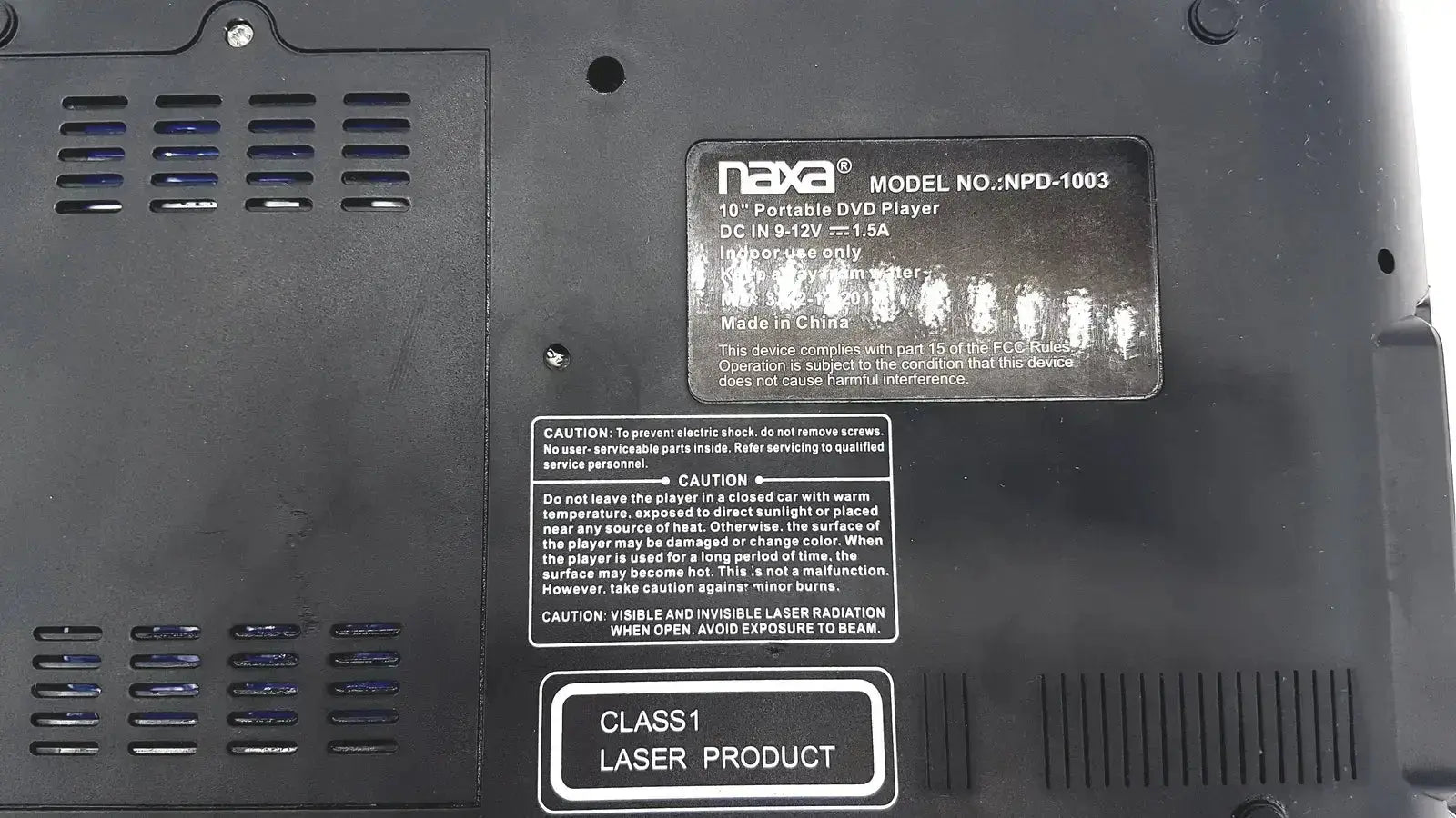 Black plastic naxa 10 inch portable dvd player npd 1003 with ventilation grilles and class 1 laser label