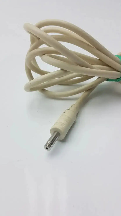 Beige nbp sensor probe cable with straight metallic barrel connector and green tie securing the coiled cord