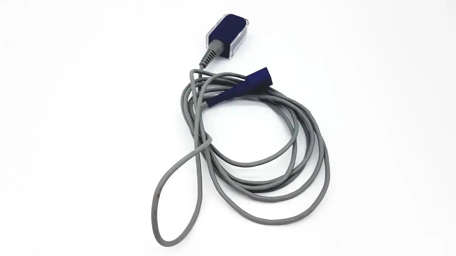 Gray coiled nellcor dec-8 adapter extension spo2 cable with dark blue sensor head and matching cap for medical use