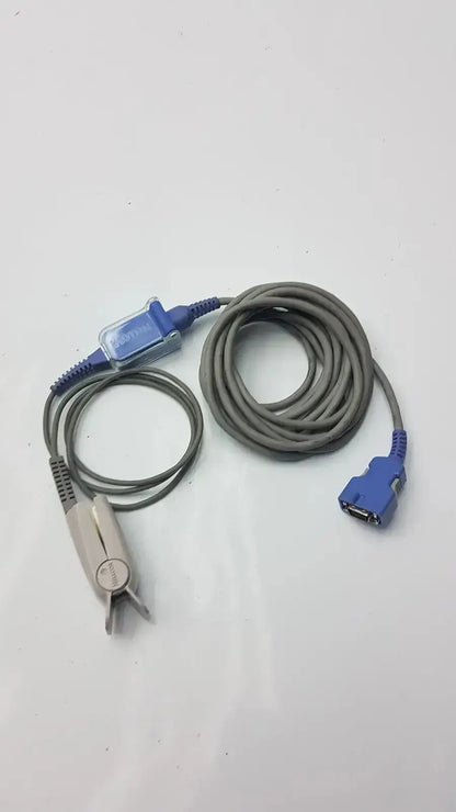 Gray coiled Nellcor finger clip extension cable with blue connectors and beige clip attachment used medical equipment for sale