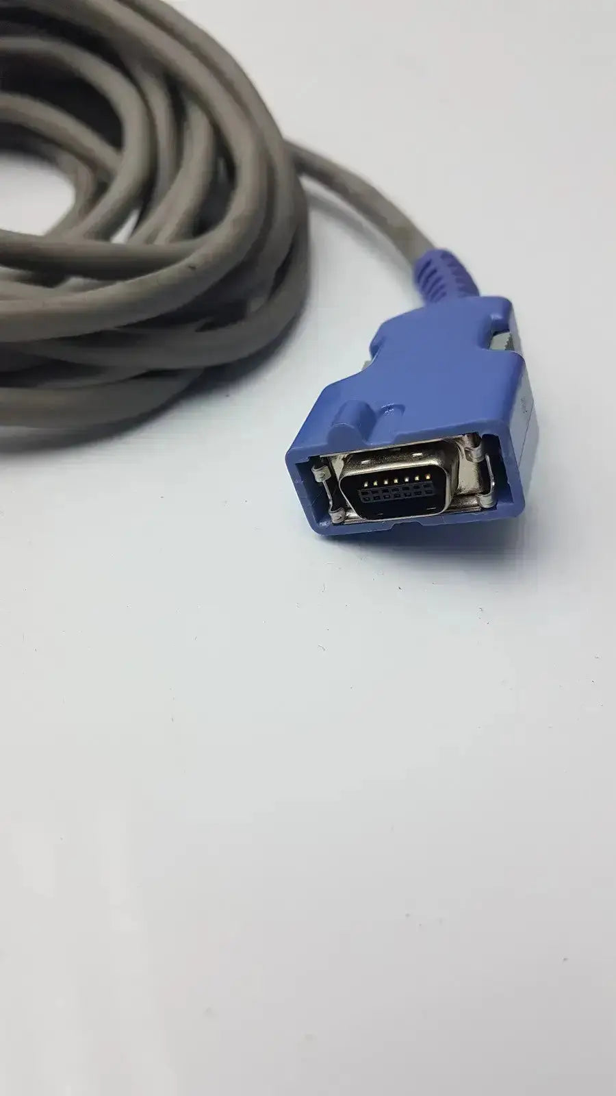 Blue plastic connector with metallic pin array and gray ribbed strain relief used in nellcor finger clip extension cable