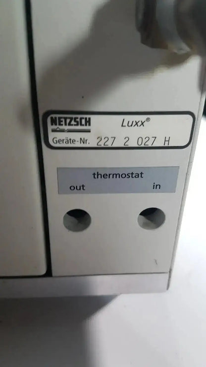 Back view of the white netzsch luxx thermostat with labeled out and in ports for simultaneous thermal analyzer use