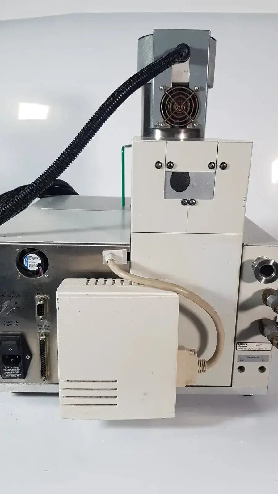Beige and gray Netzsch GmbH STA 409 PC Luxx simultaneous thermal analyzer with black cable connected on top