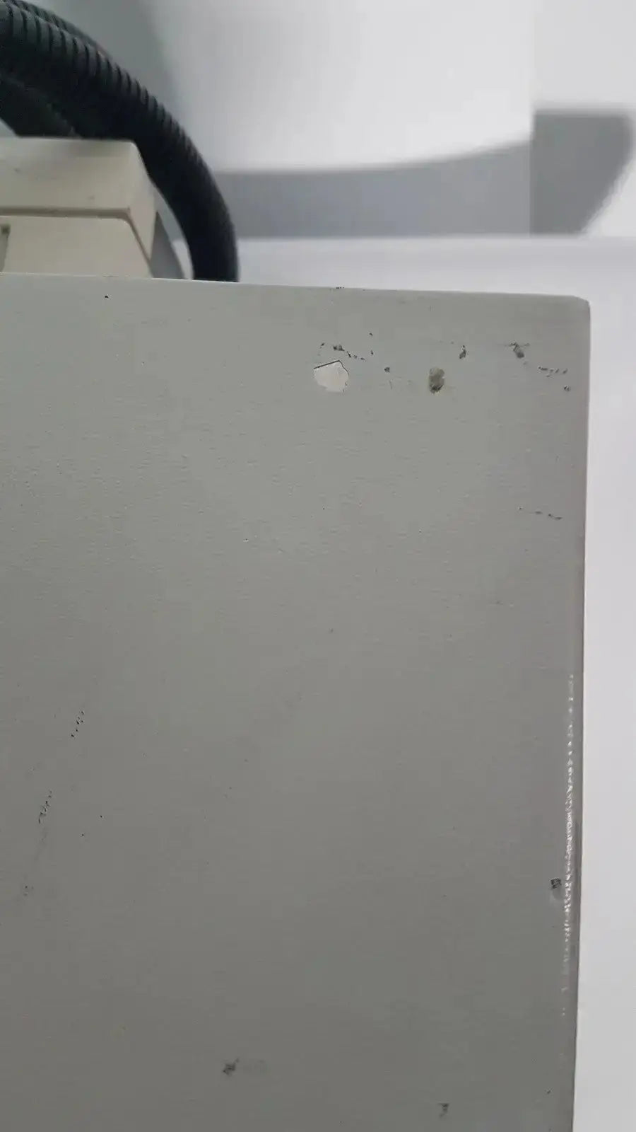 Gray rectangular metal panel with minor scratches on the back side of netzsch gmbh sta 409 pc luxx simultaneous thermal analyzer