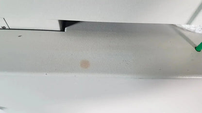 Beige circular stain on white painted metal surface of netzsch gmbh sta 409 pc luxx simultaneous thermal analyzer