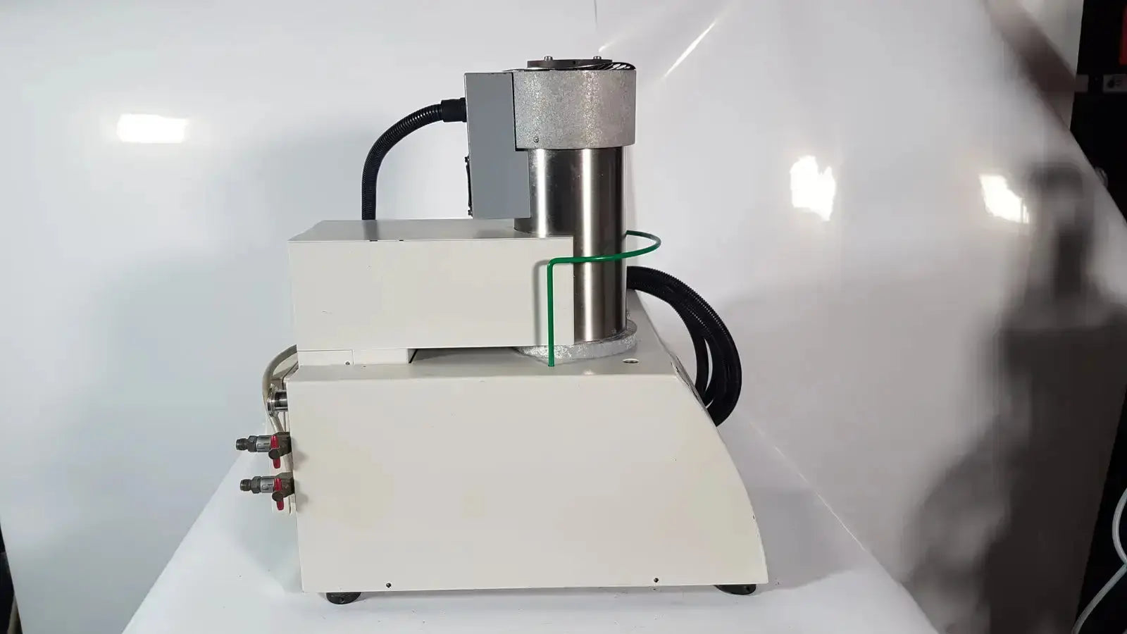 Industrial-grade white and metallic gray hydraulic press with black hoses and red fittings for Netzsch simultaneous thermal analyzer