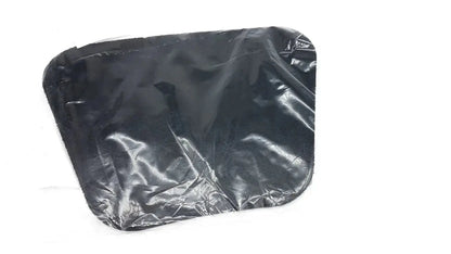 Black plastic trash bag with crinkled surface and rounded corners shown as moldable lumbar insert packaging back side