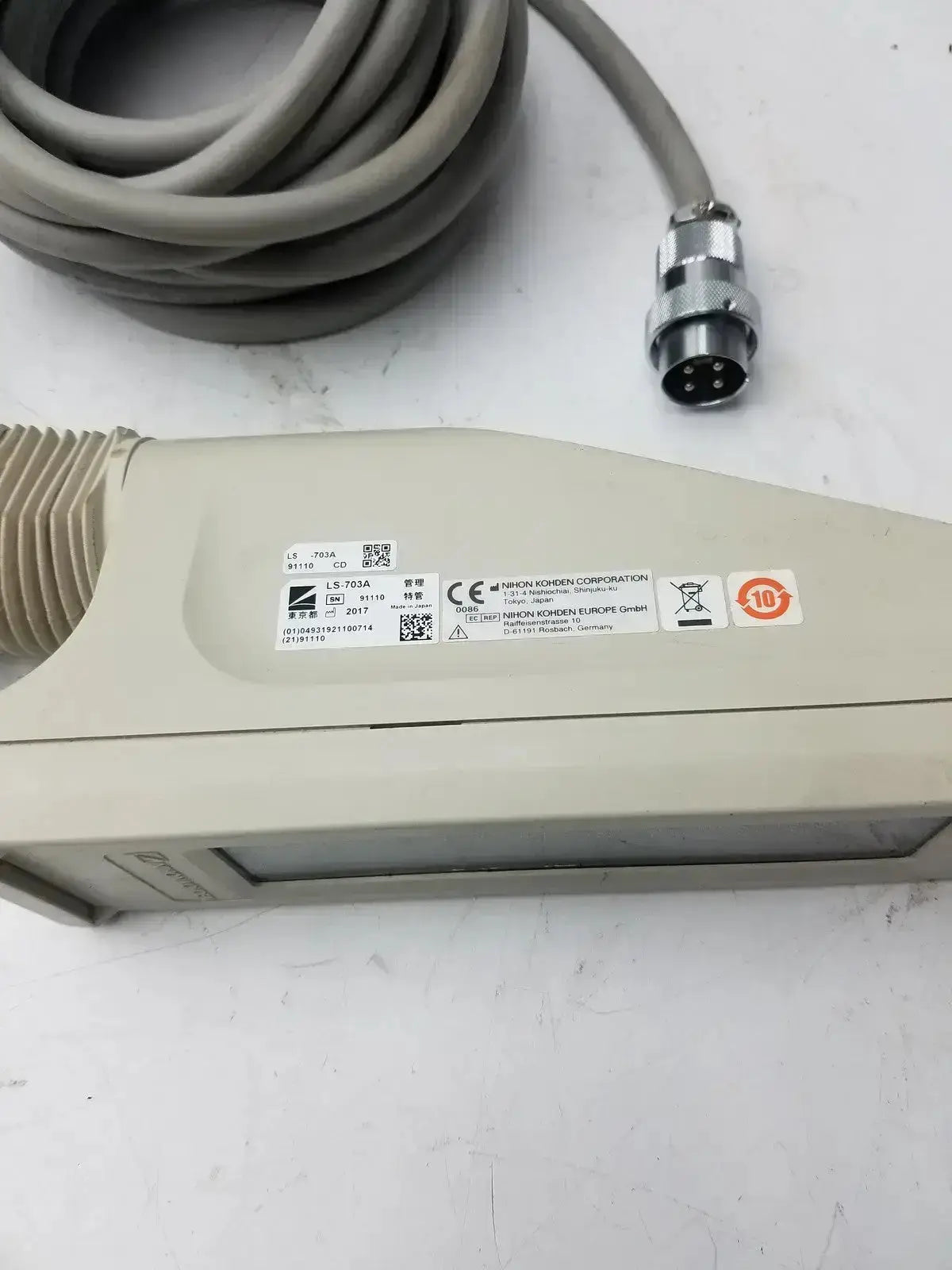 Beige plastic nihon kohden ls-703a photic stimulator sensor with coiled gray cable and metallic connector
