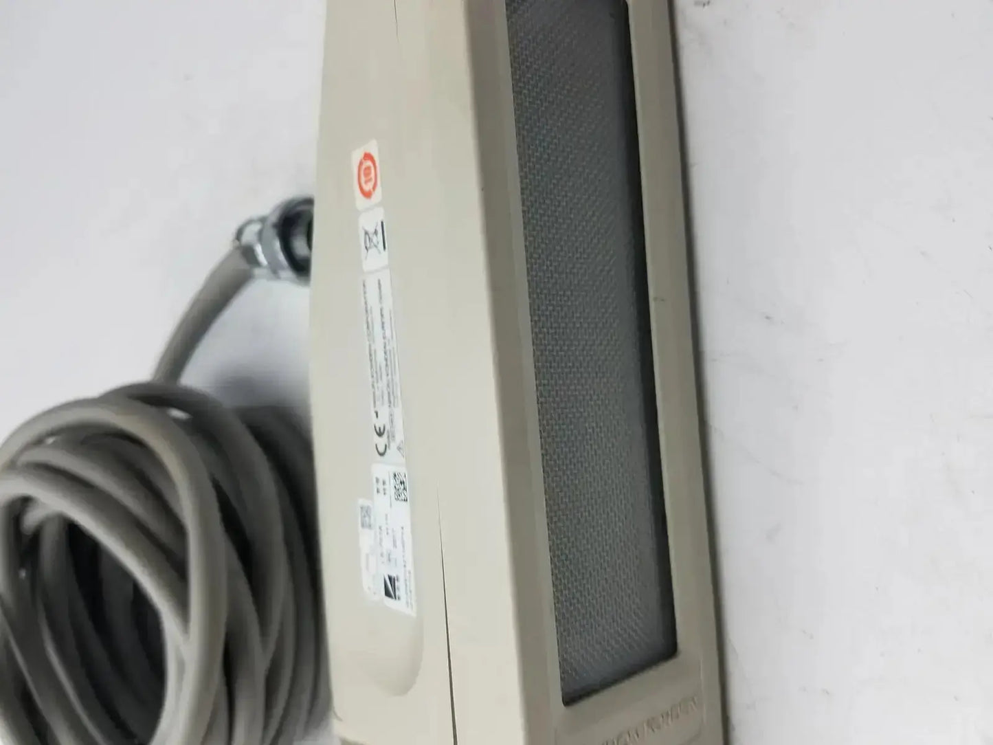 Beige nihon kohden ls-703a photic stimulator with textured gray front panel and attached coiled gray cable