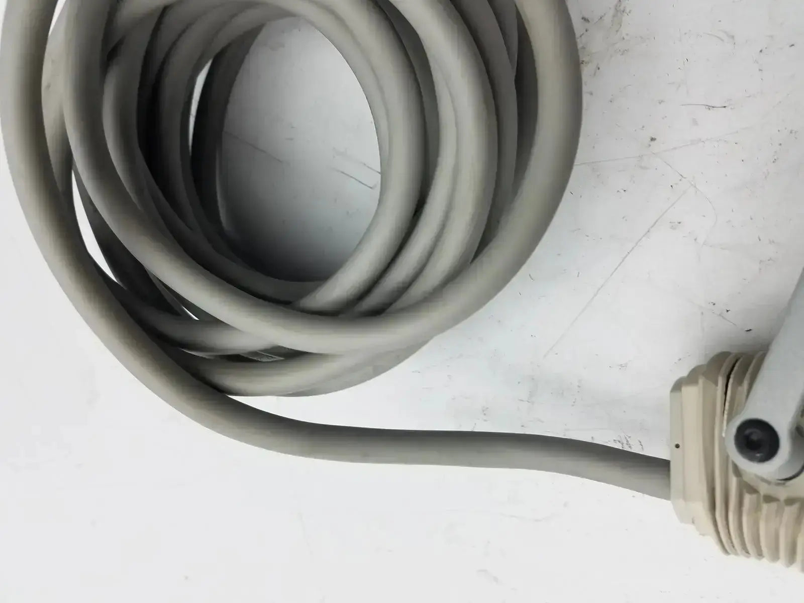Coiled gray rubber hose with beige plastic connector for nihon kohden ls-703a photic stimulator device