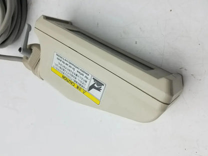 Beige plastic nihon kohden ls-703a photic stimulator with coiled gray cable and warning label