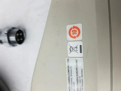 Beige plastic nihon kohden ls-703a photic stimulator showing orange recycling symbol and black disposal warning label on back