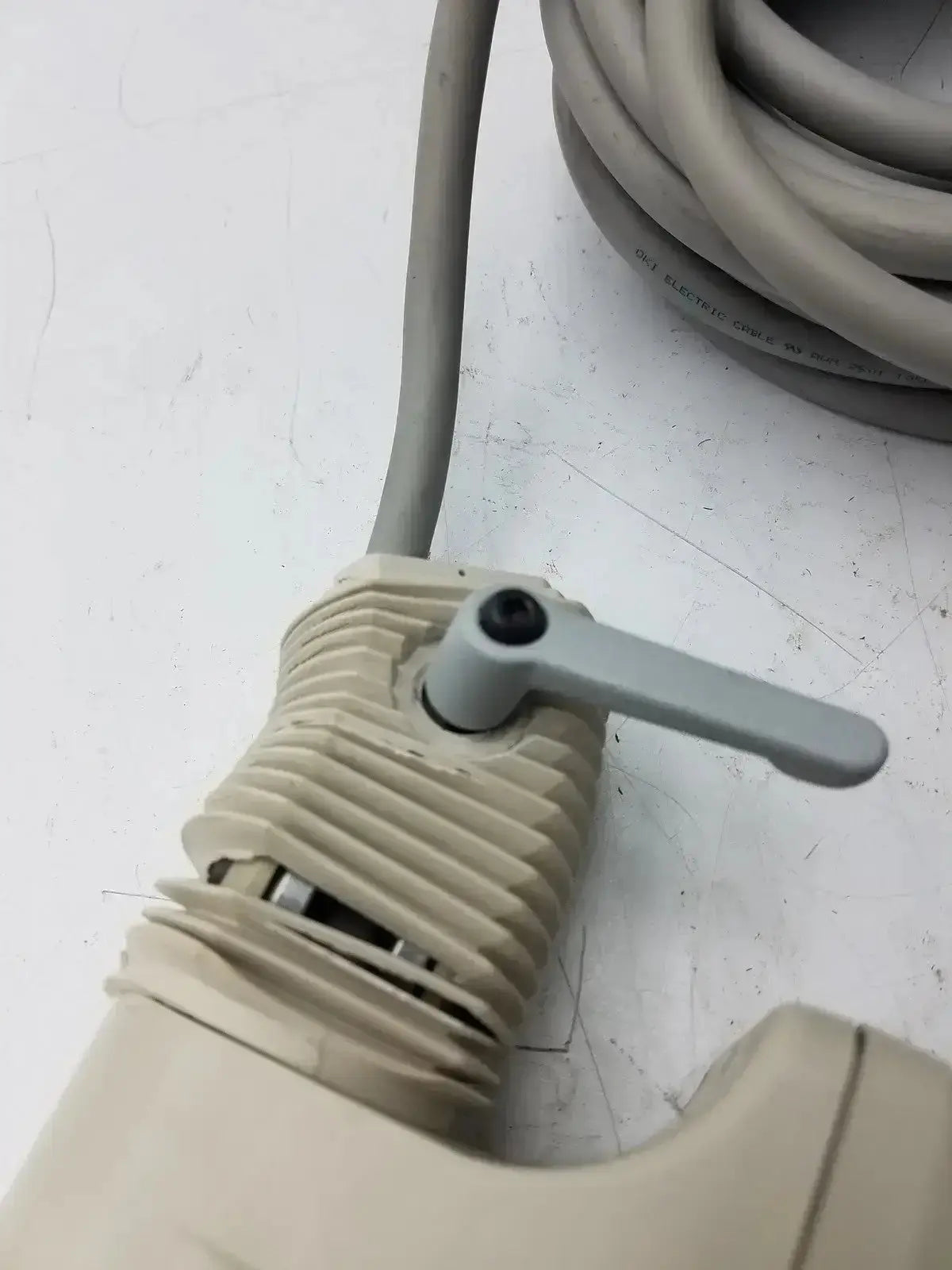 Beige plastic valve with ribbed body and gray handle on nihon kohden ls-703a photic stimulator device