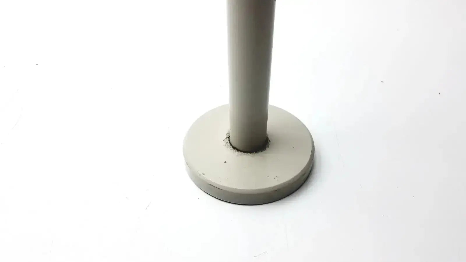 Gray cylindrical stand with flat circular base for Nikon 030039 binocular microscope, ideal to buy used medical equipment