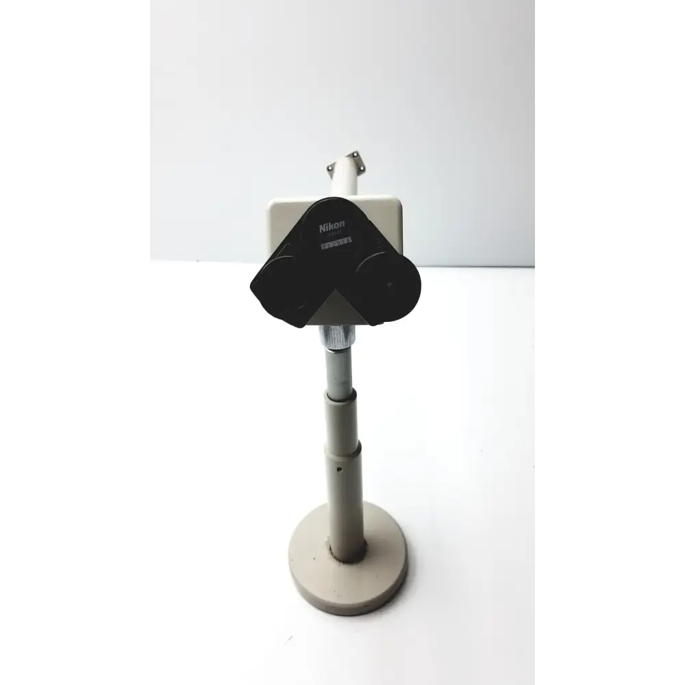 Black nikon stereo microscope mounted on a gray adjustable stand.