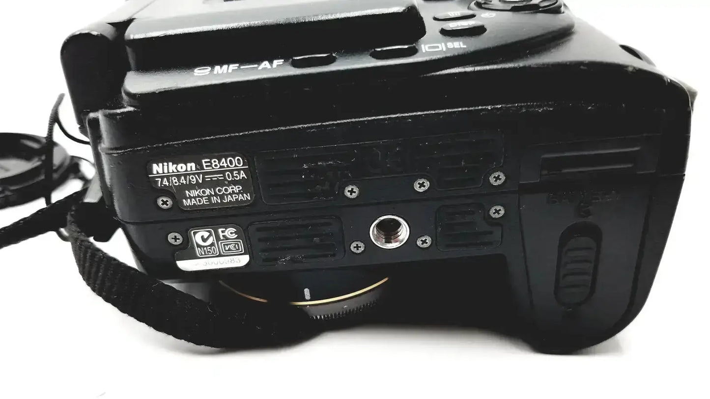 Black nikon coolpix e8400 digital camera body with matte finish showing model and specifications on the back side for reliable monitoring