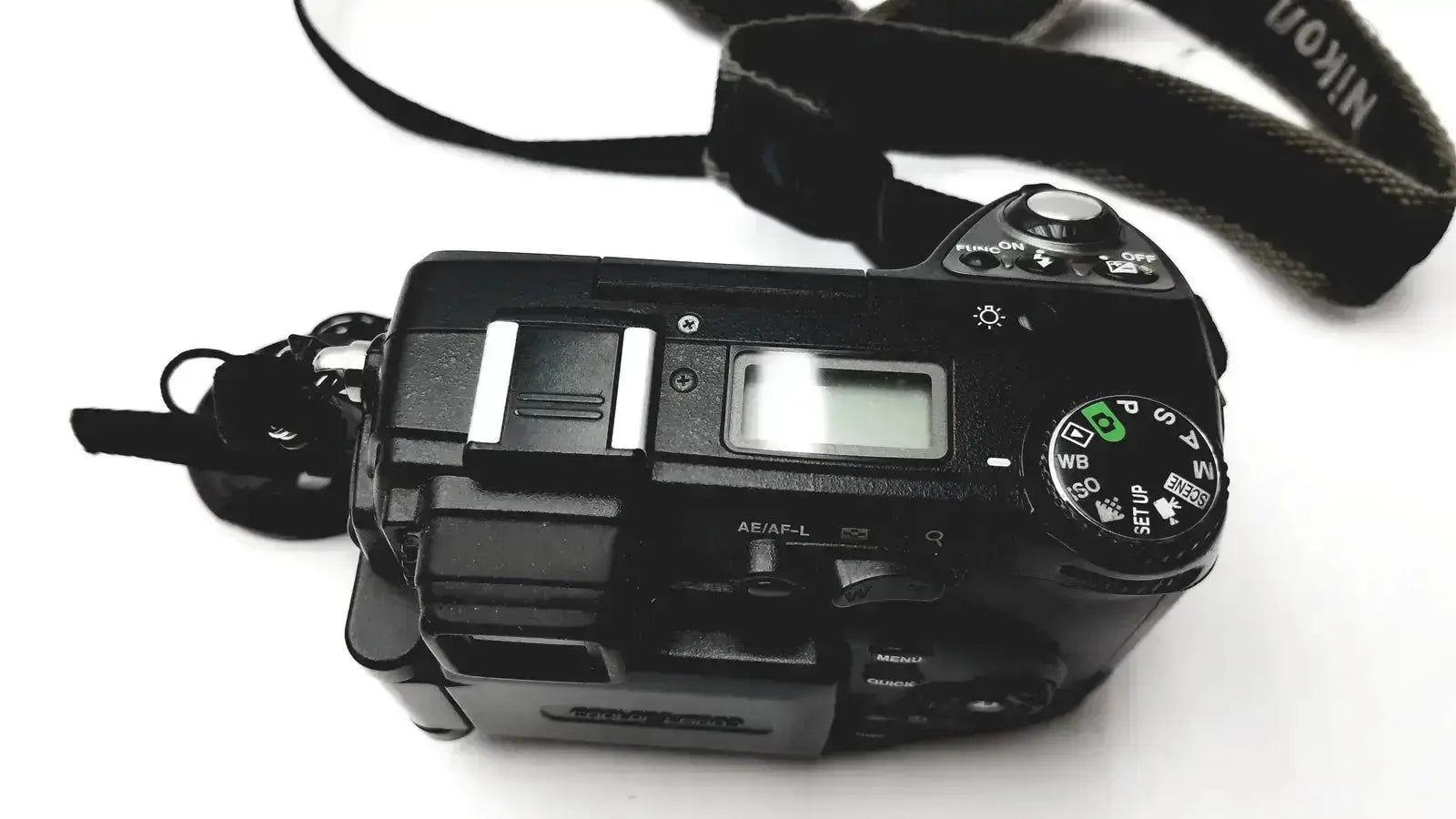 Black Nikon Coolpix E8400 digital camera with textured strap and visible control dials for reliable monitoring