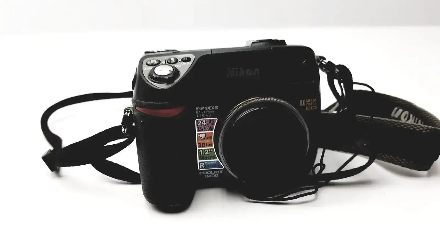 Black nikon coolpix e8400 digital camera with textured grip and visible lens specifications for reliable monitoring
