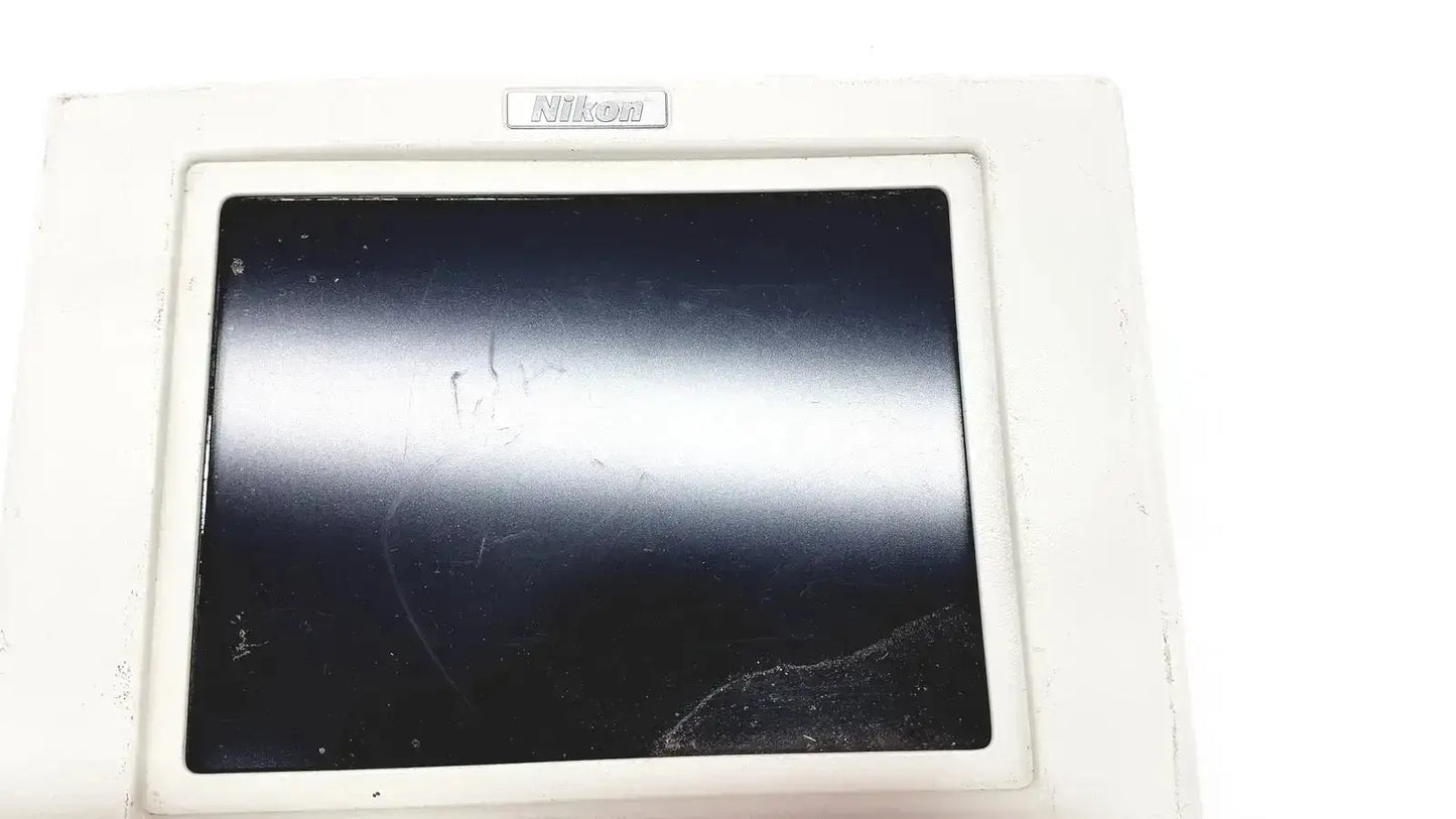 White nikon digital sight microscope camera controller with black scratched screen showing back side of the device