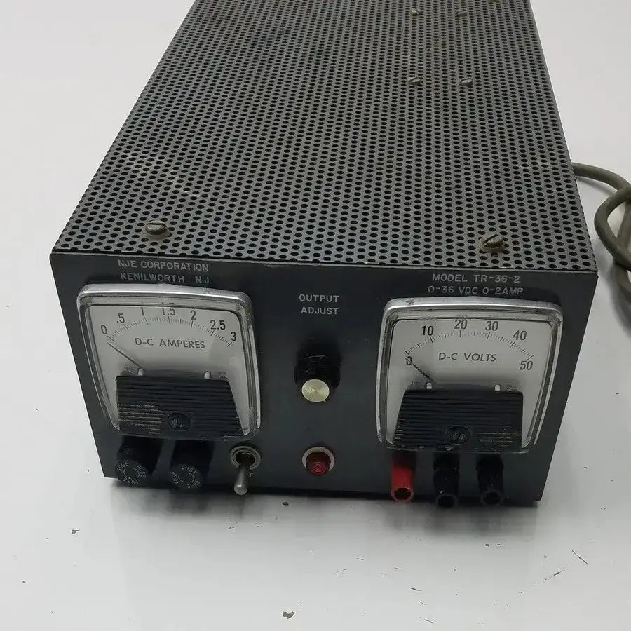 Black metal nje corporation power supply model tr-36-2 with two analog meters for d-c volts and amperes
