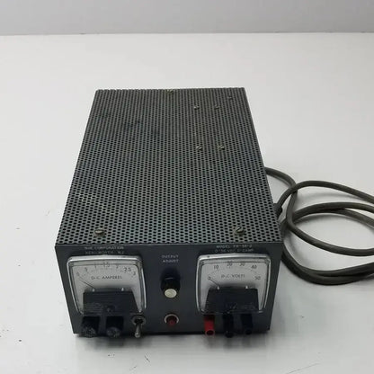 Black metal nje corporation power supply model tr-56-2 with perforated front panel and analog ammeter and voltmeter
