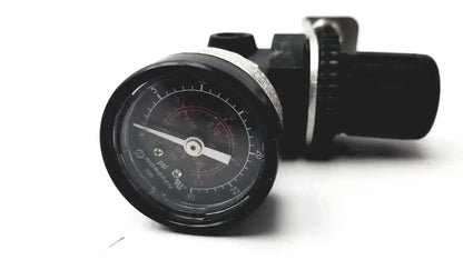 Black vdo pressure gauge with circular dial in psi and bar on norgren r07-100-rgka mini pressure regulator