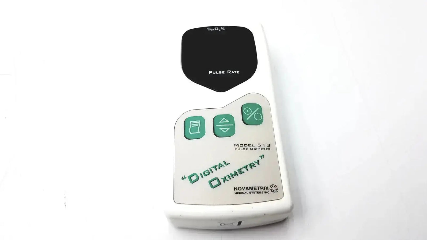 White plastic Novametrix 513 pulse oximeter monitor with black display and green pulse rate buttons for accurate readings