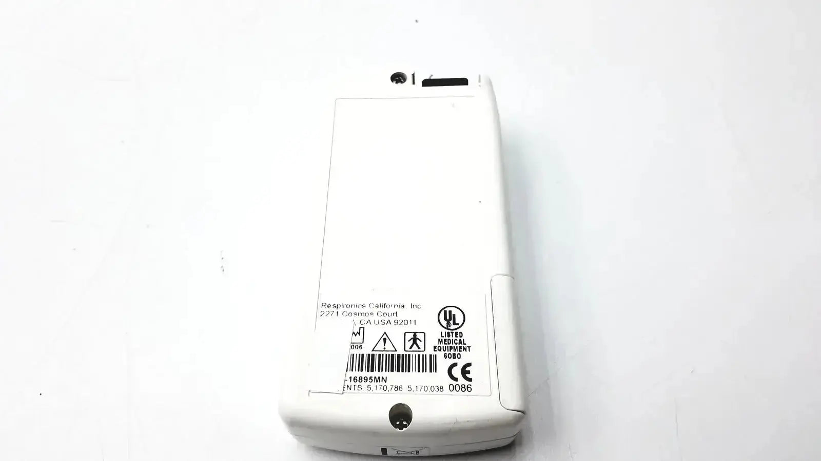 White plastic Novametrix 513 pulse oximeter monitor with printed labels and certification marks on the back side