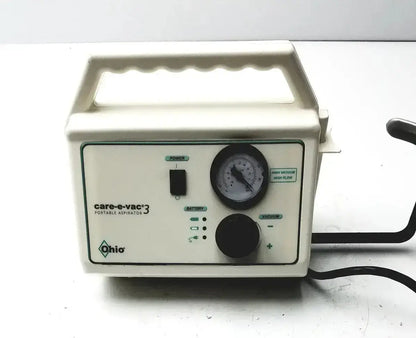 Cream-colored plastic ohio medical care-e-vac 3 portable aspirator with black power switch pressure gauge and control knobs