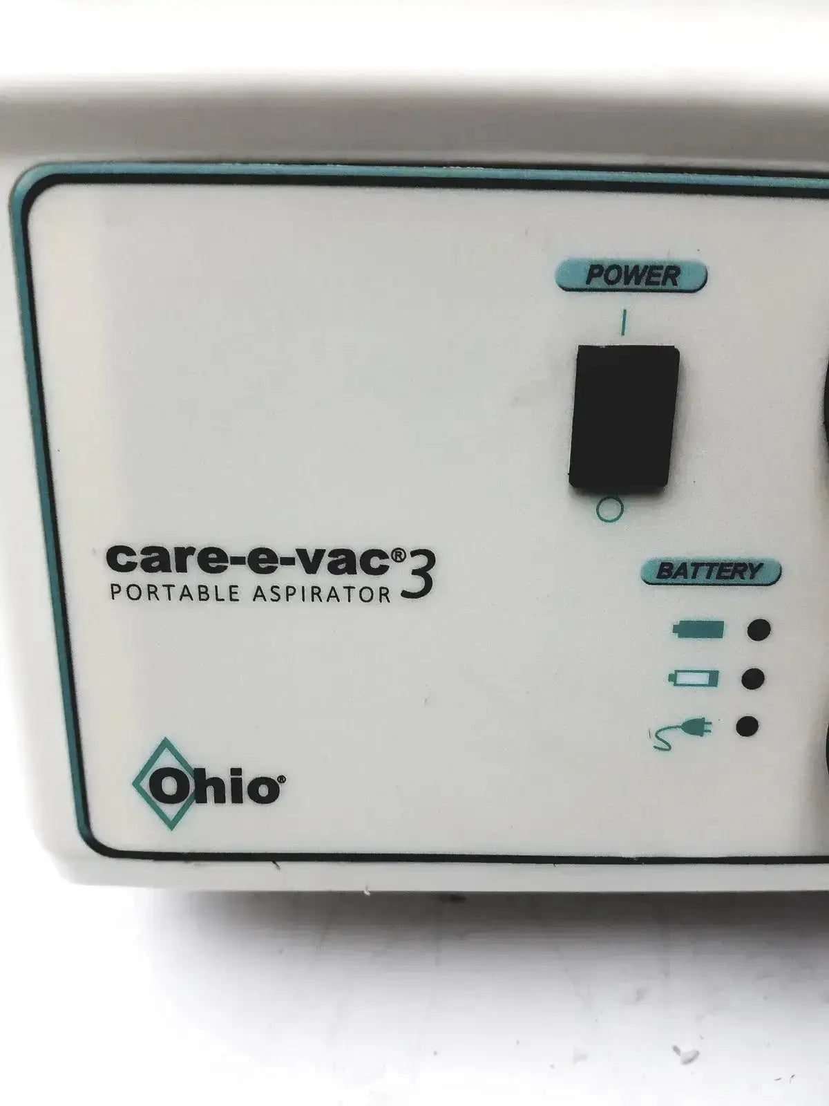 White plastic ohio medical care-e-vac 3 portable aspirator control panel with teal accents and labeled power switch