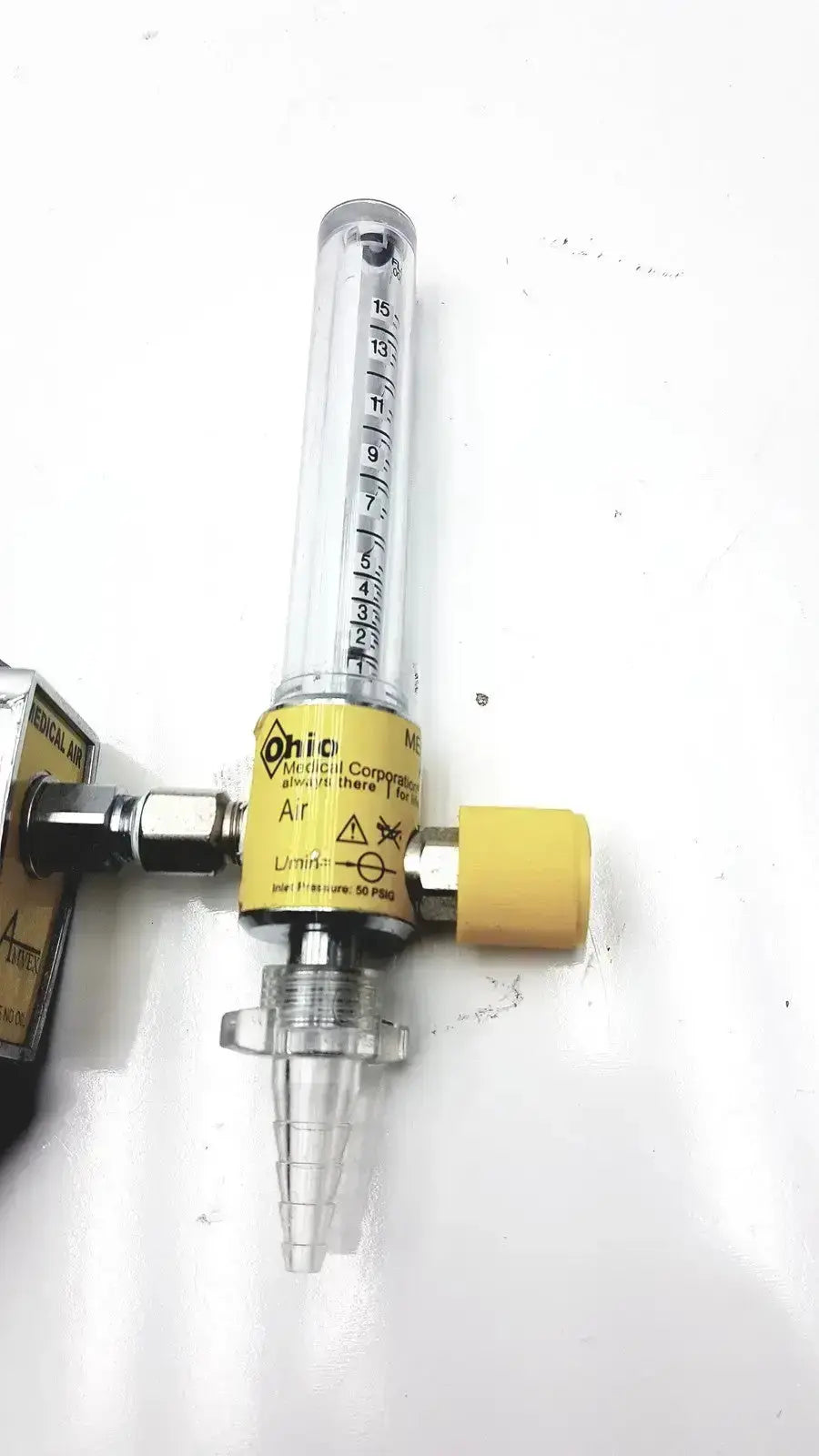 Yellow and clear plastic ohio medical compressor air flow meter with inlet pressure 50 psig and measurement markings