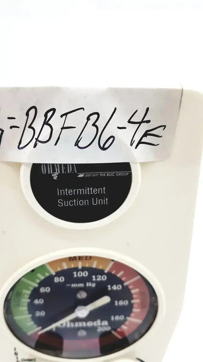 White plastic ohmeda ffa19643 intermittent suction unit with circular gauge displaying pressure readings in mm hg