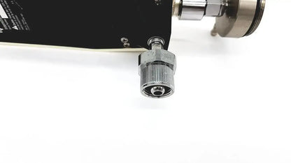 Silver metallic threaded connector with hexagonal nut and flanged end attached to black industrial component of ohmeda ffa19643 intermittent unit
