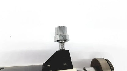Silver knurled knob on a hexagonal nut mounted on a black triangular base of ohmeda ffa19643 intermittent unit