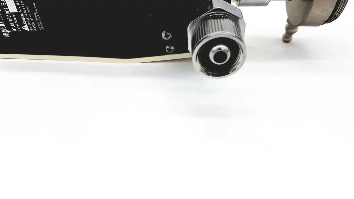 Black skateboard deck with metallic silver threaded connector and screws on ohmeda ffa19643 intermittent unit back side