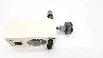 Cream-colored ohmeda ffa19643 intermittent unit oxygen flow meter with circular gauge and metallic fittings