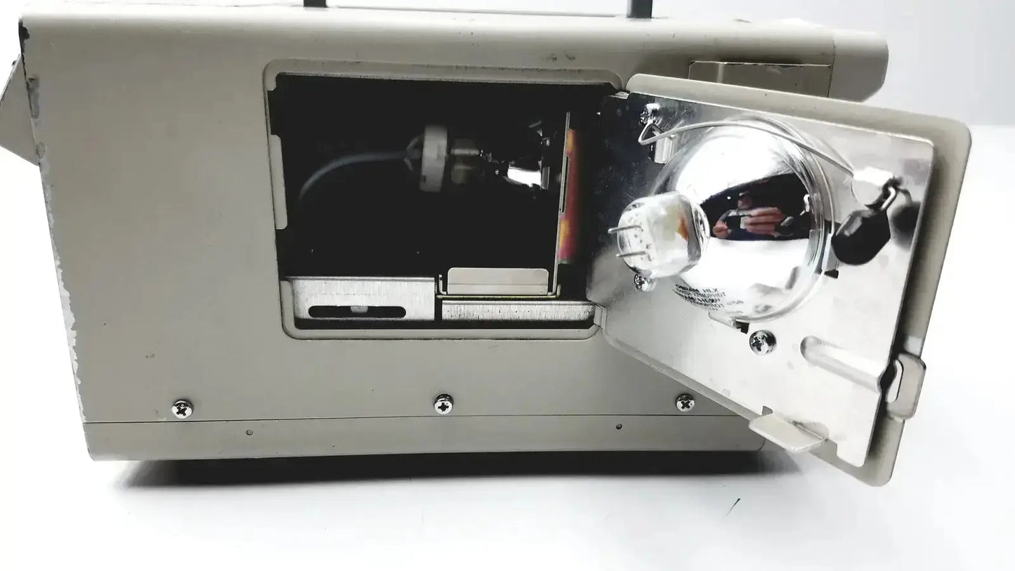 Gray metal Olympus CLK-4 halogen light source with reflective silver lens assembly and visible internal components