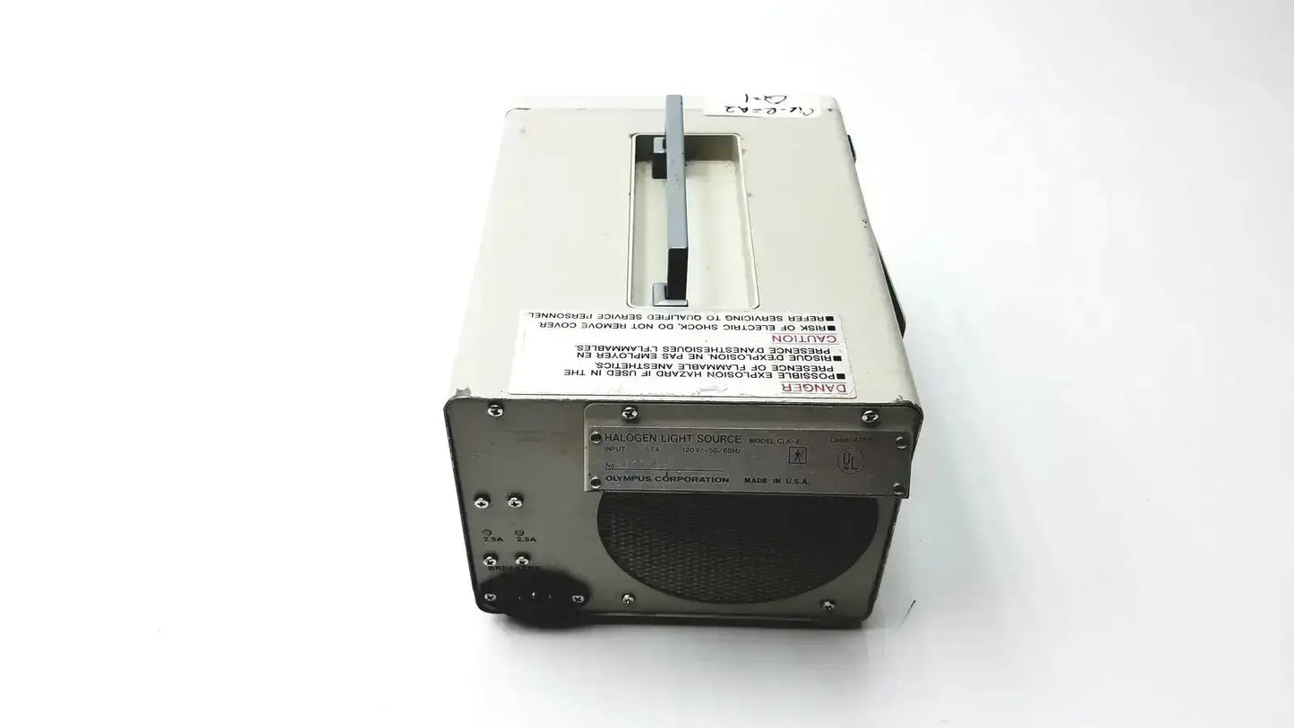 Metallic gray industrial-grade battery charger with sturdy construction for olympus clk-4 halogen light source use