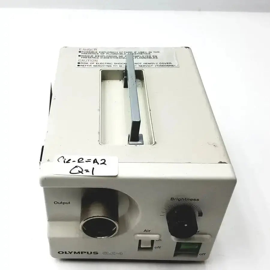 White plastic olympus clk-4 halogen light source with black output port and brightness dial for medical use