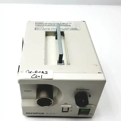 White plastic olympus clk-4 halogen light source with black output port and brightness dial for medical use