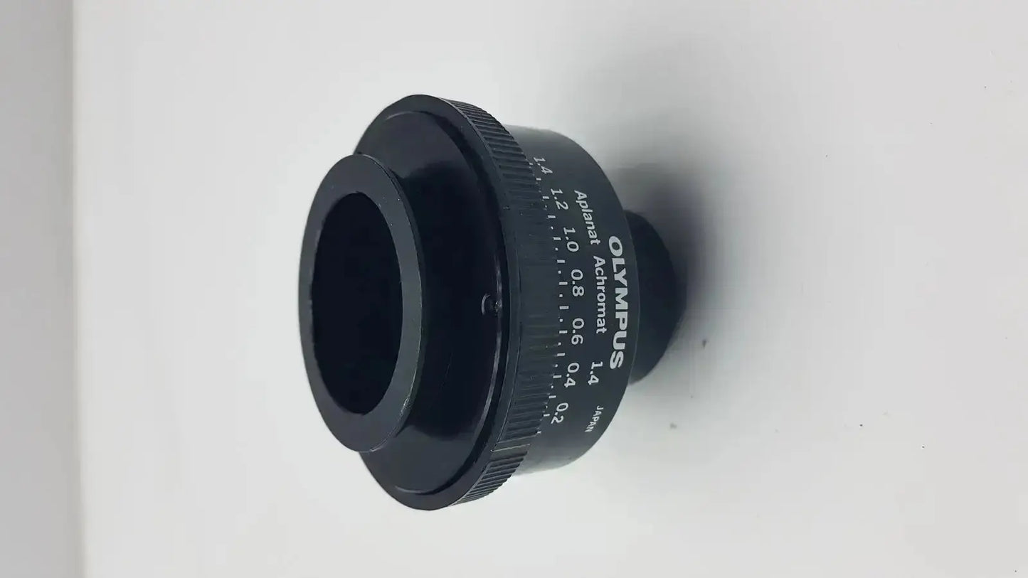 Black Olympus microscope condenser aplanat achromat 1.4 with engraved markings and textured focus ring adapter
