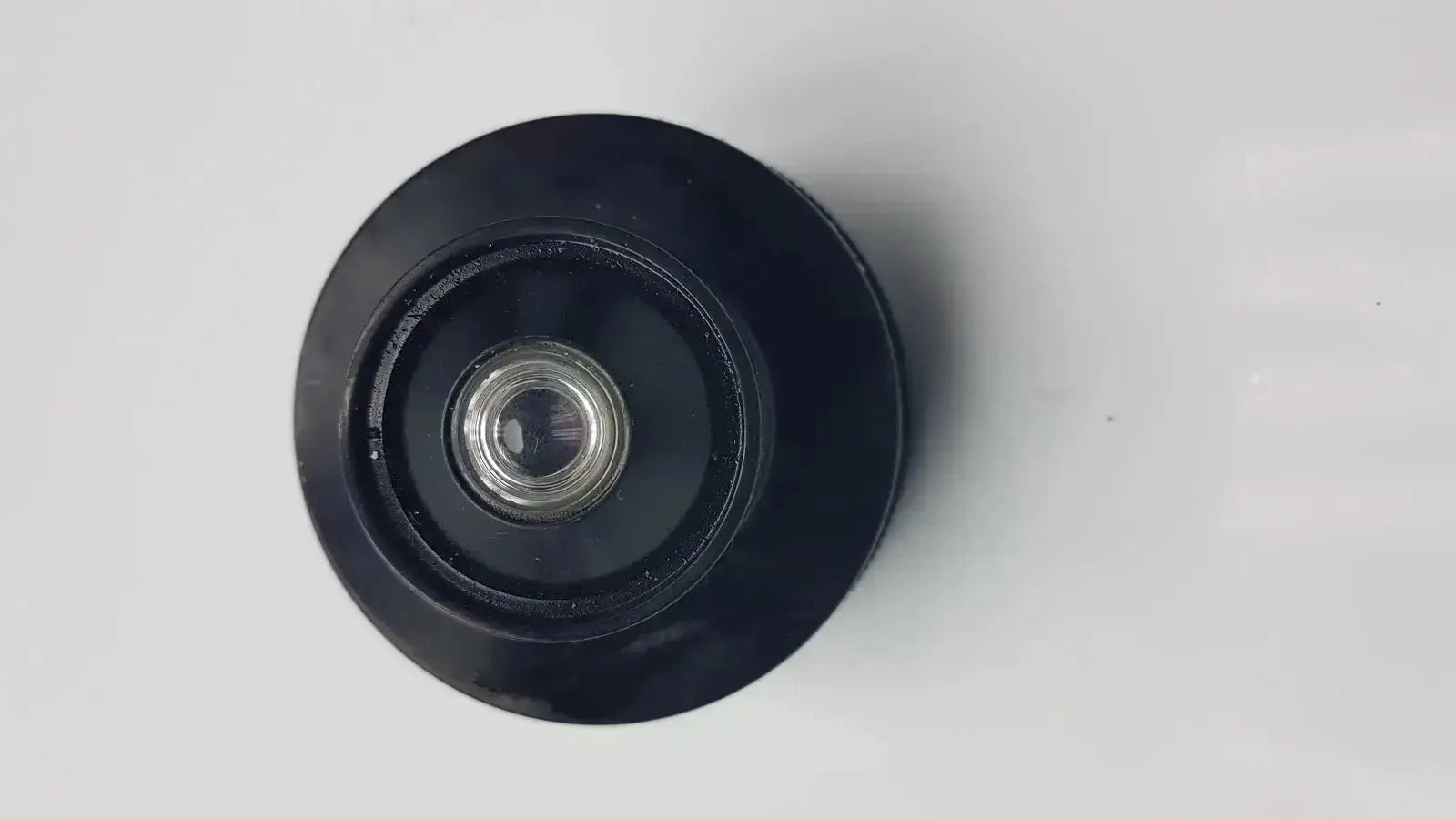 Black circular olympus microscope condenser aplanat achromat 1.4 lens with metallic silver center for precise microscopy