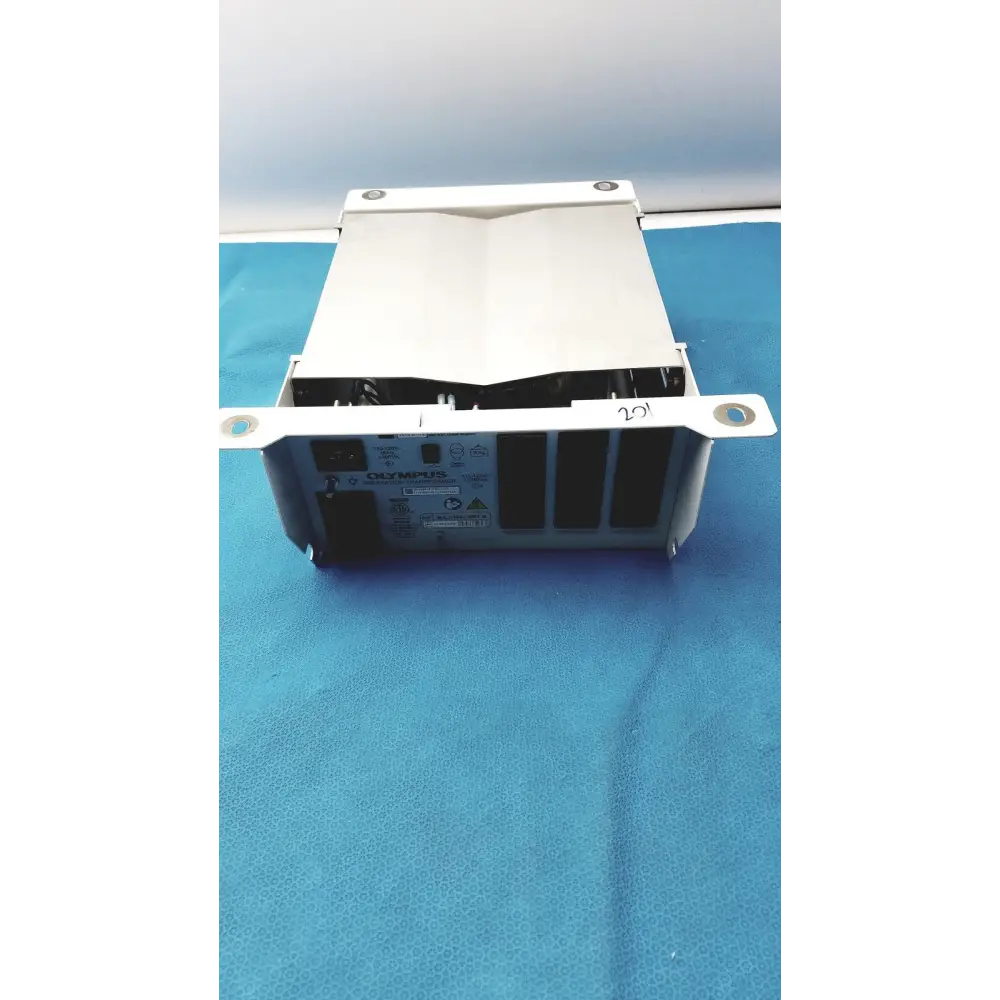 White olympus medical imaging device with a metallic frame and black internal components.