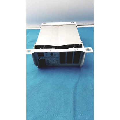 White olympus medical imaging device with a metallic frame and black internal components.