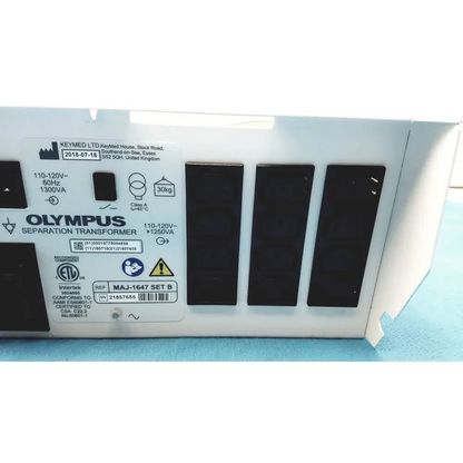 White olympus separation transformer with black rectangular panels and a label displaying technical specifications, certification marks, and model reference.