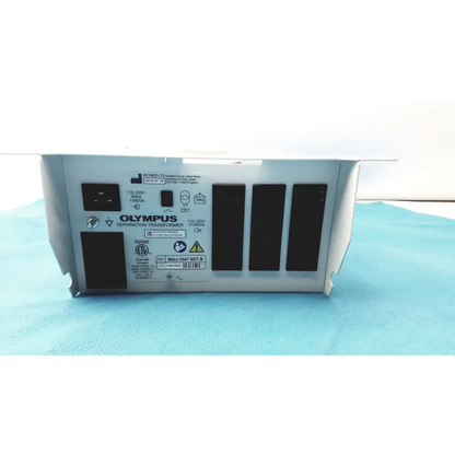 Silver metallic olympus separation transformer with black ventilation slits and labeled specifications on its rear panel.